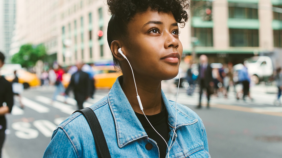 Woman in street with earphones